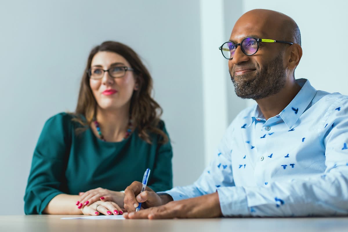 an attorney discussing a case with a client at her international law firm in Cayman Islands