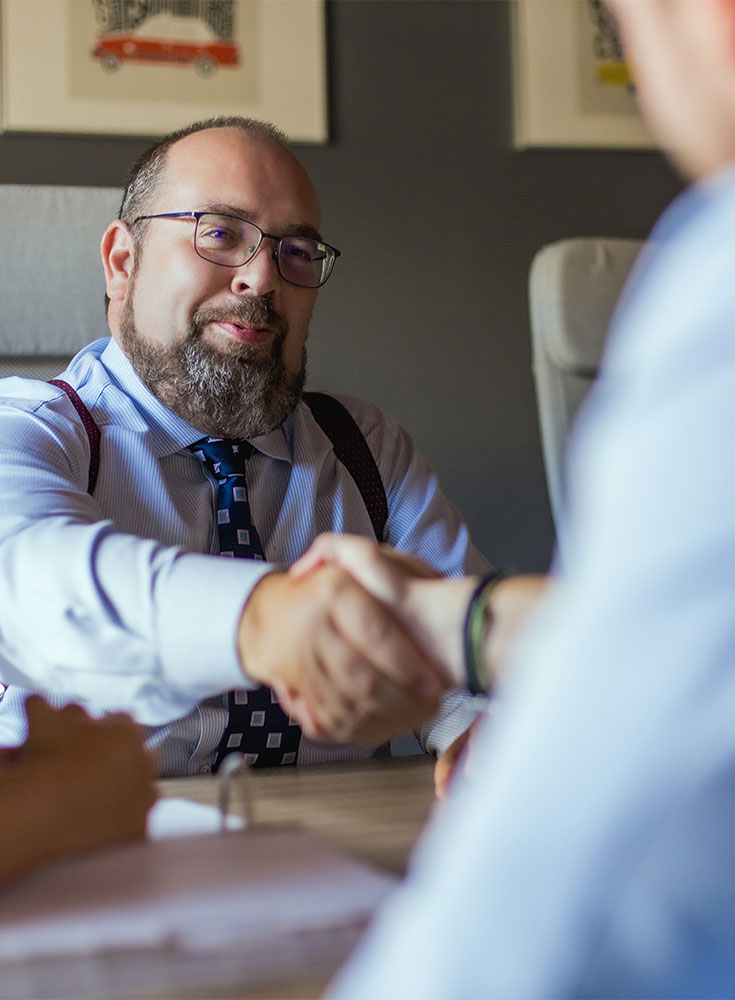 a lawyer in Cayman Islands shakes hands with a client